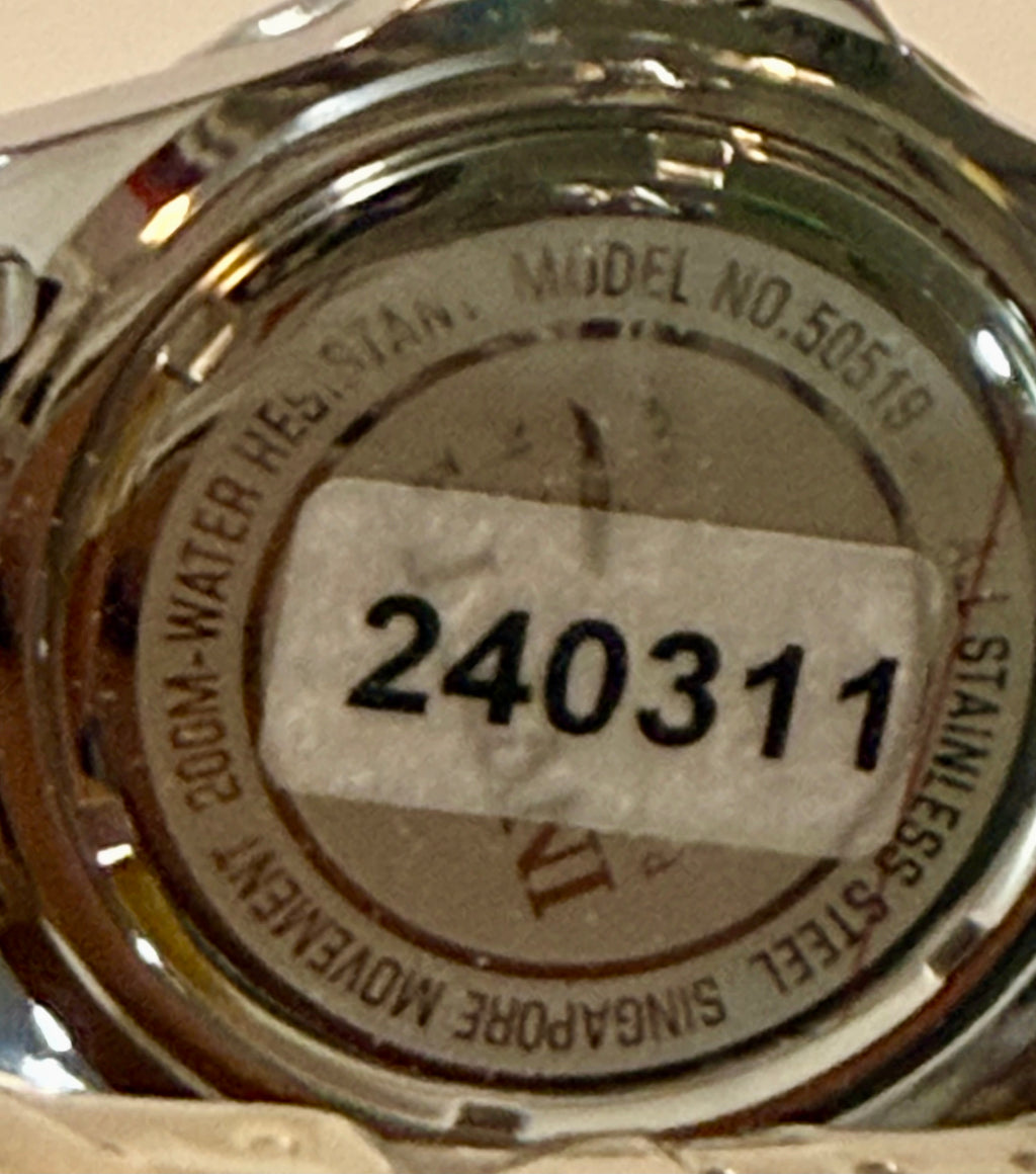 Close-up of a watch case with model number 50519 and serial number 240311.