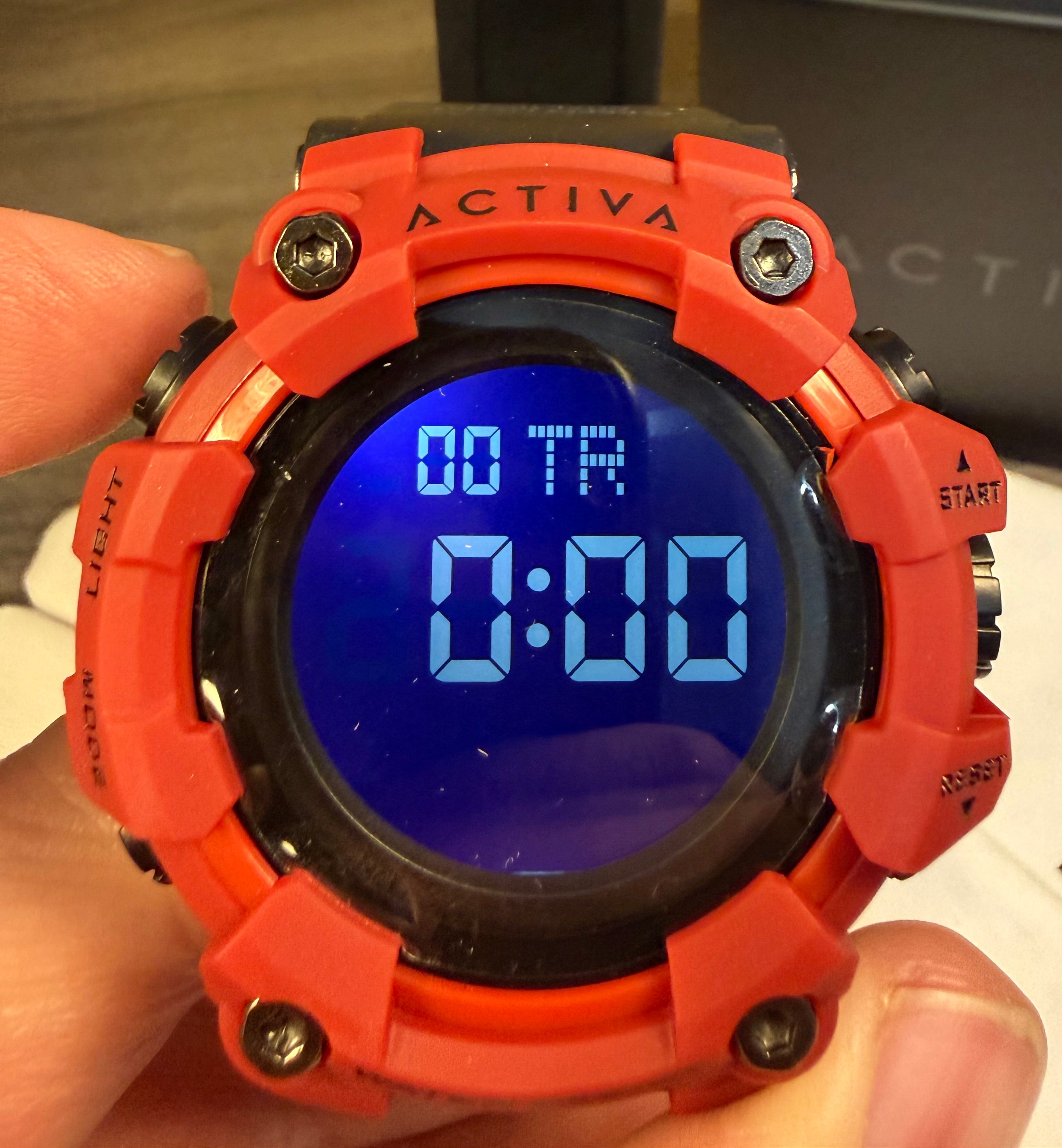 Activa Red digital watch with blue screen held by a hand