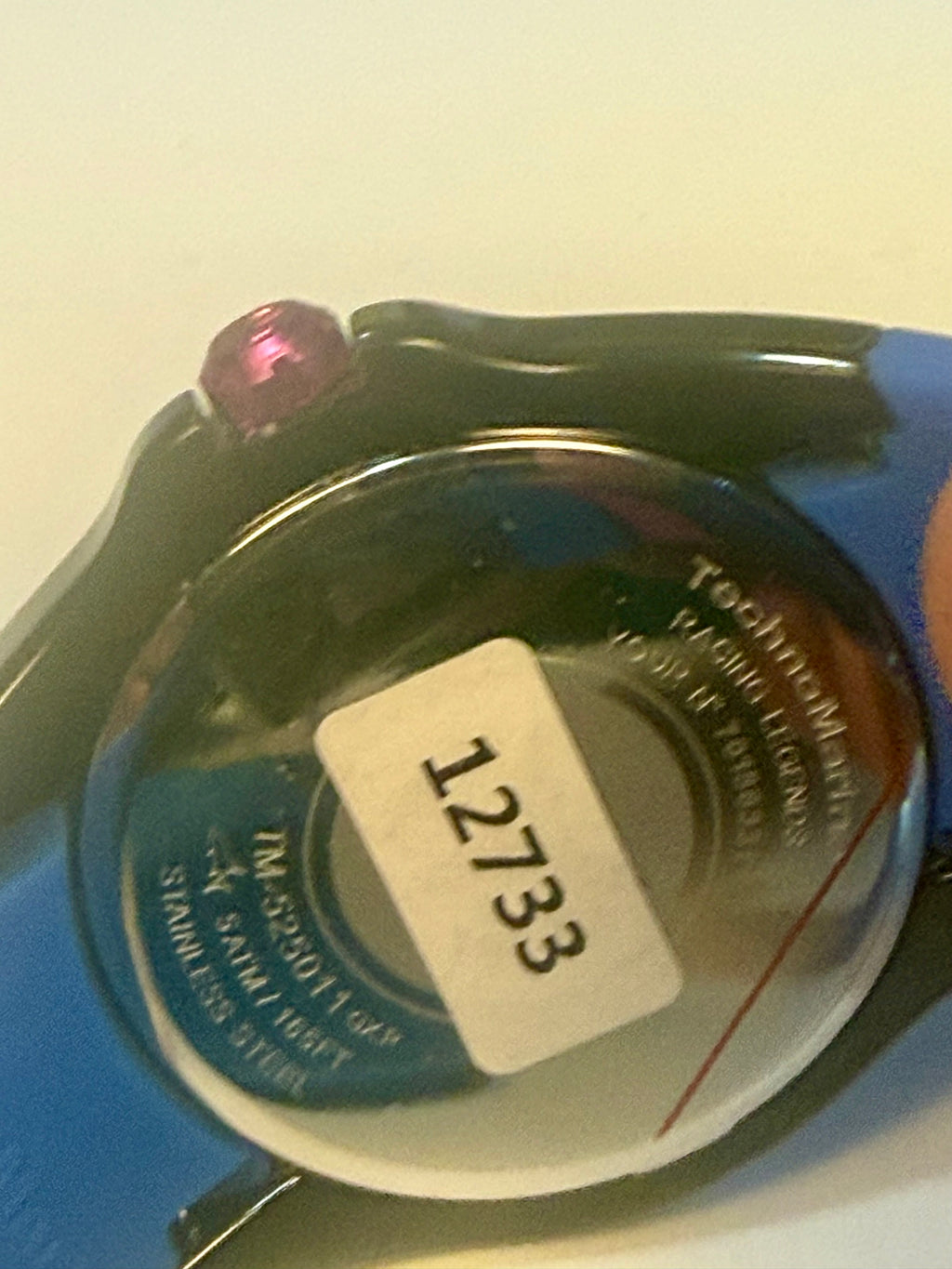 Close-up of a Techno Marine Racing Legends 44mm Wristwatch  watch with a blue band and a visible model number on a light background