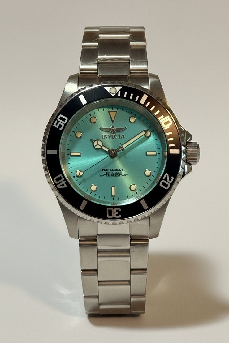 Invicta Pro Diver 47356 Men 40mm Quartz Turquoise Blue Dial Steel Sport Watch watch with a turquoise face on a white background