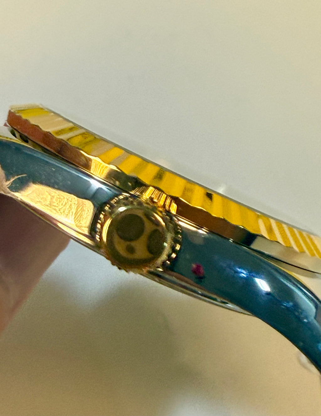 Close-up of a gold and blue Invicta Mens Specialty Belmont 43mm watch with a white background