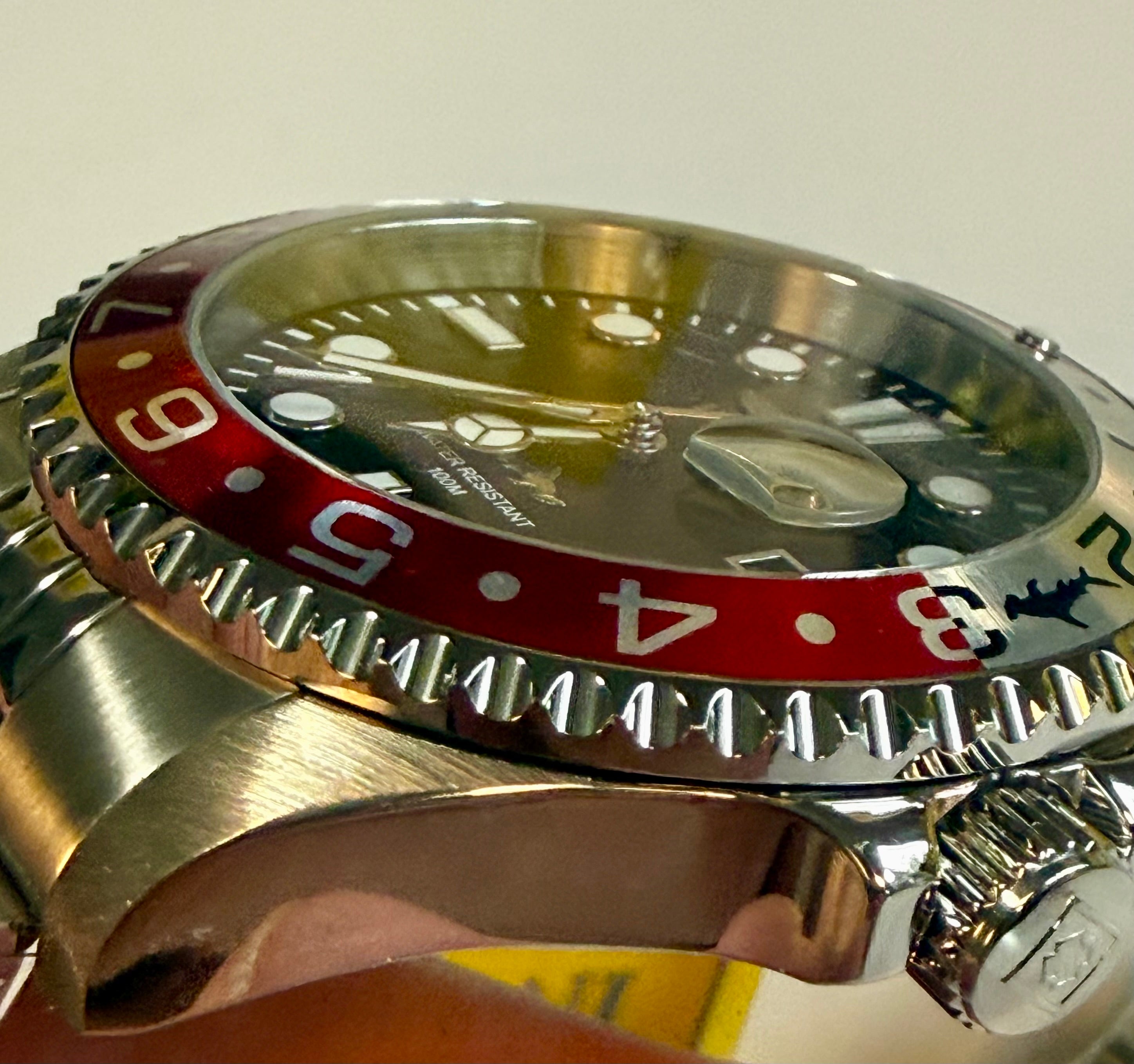 Close-up of a Invicta Mens Pro Diver 43mm Heritage  with a red and black bezel on a light gray background