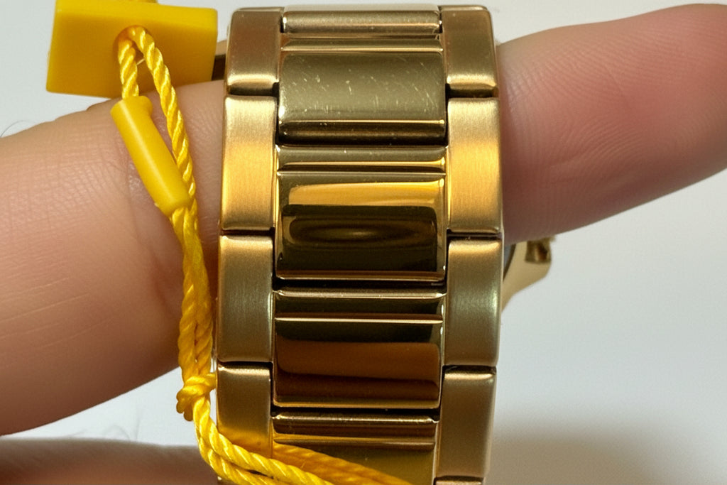 Invicta Speedway 46840 Gold Dial Gold Plated Steel 42mm Quartz Men's Watchon a wrist with a yellow cord in the background