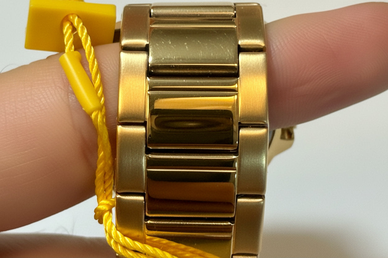 Invicta Speedway 46840 Gold Dial Gold Plated Steel 42mm Quartz Men's Watchon a wrist with a yellow cord in the background