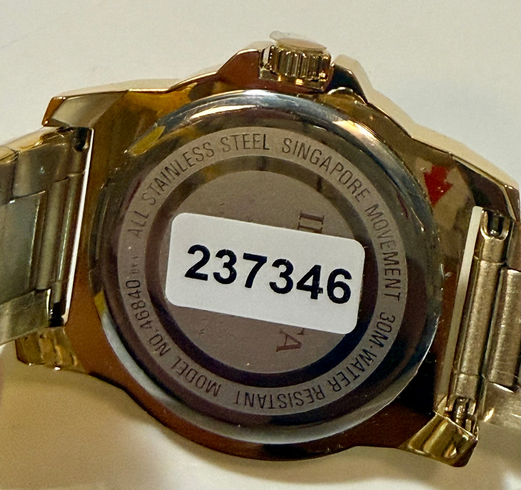 Back of a gold watch with model number 237346 on a white background