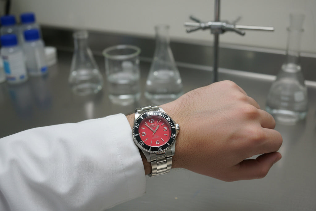Invicta Specialty Rowan Wristwatch with red face and silver band on a light gray background