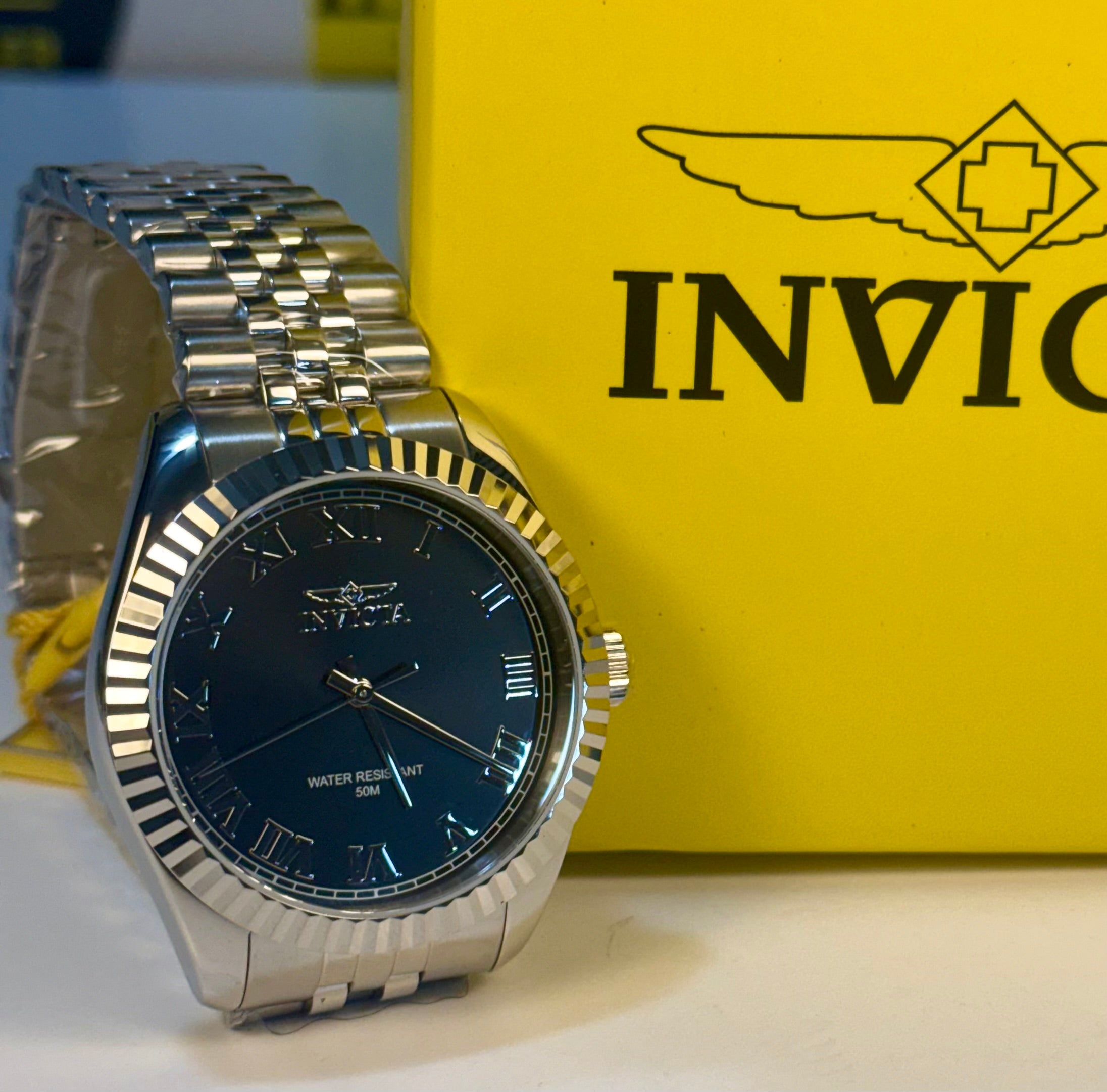 Mens Specialty Rowan 43mm Silver watch with blue face on a yellow Invicta box