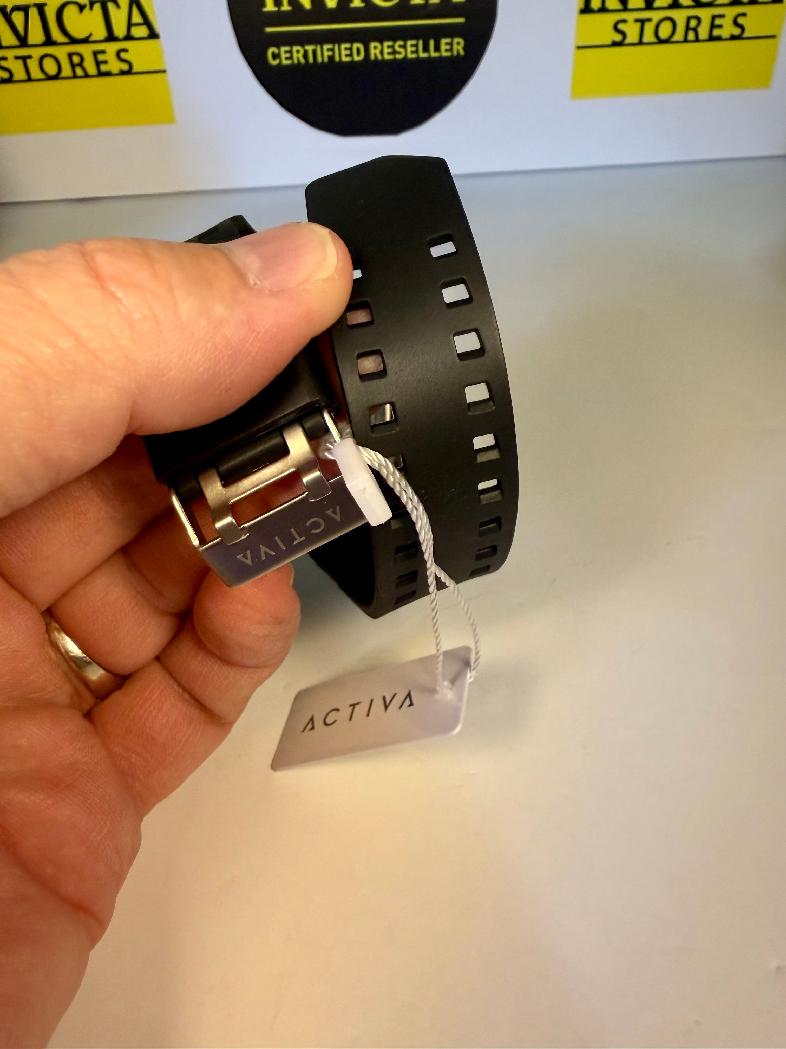 Hand holding a Invicta Activa Vord X watch band with 'Activa' label against a white background