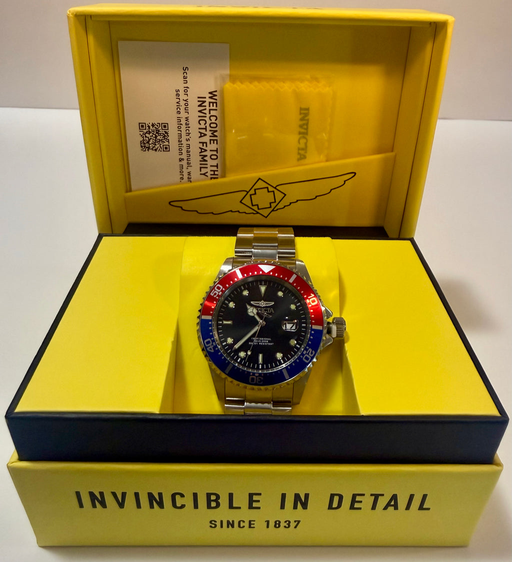 Invicta Pro Diver 23384 Men 43mm Quartz Black Dial Pepsi Blue Red in an open yellow box with 'Invincible' branding.