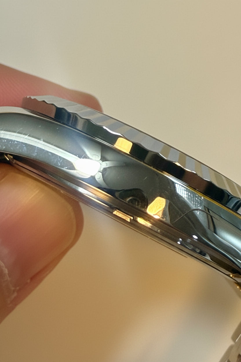Close-up of a Invicta Specialty Windsor 43mmt held by a hand against a plain background