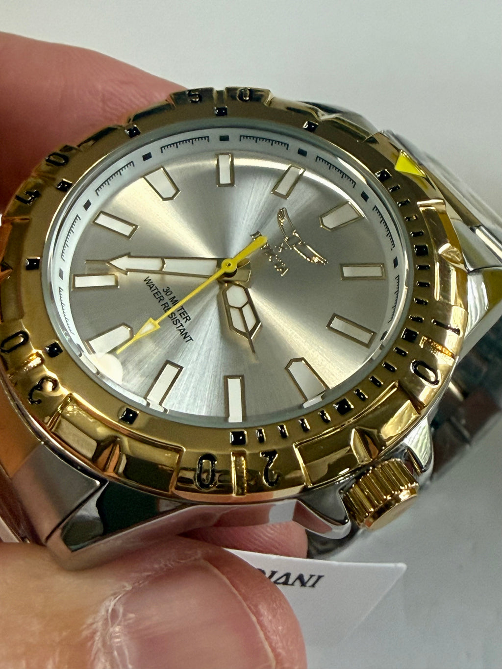 Invicta Specialty I Mens 42mm Gold and silver watch held by a hand with a white background