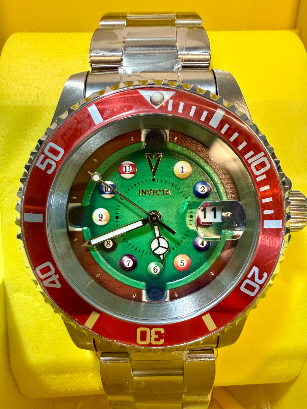 Invicta Pro Diver House of Cards Men's Watch - 40mm. Watch with a green face and red and silver accents on a yellow background