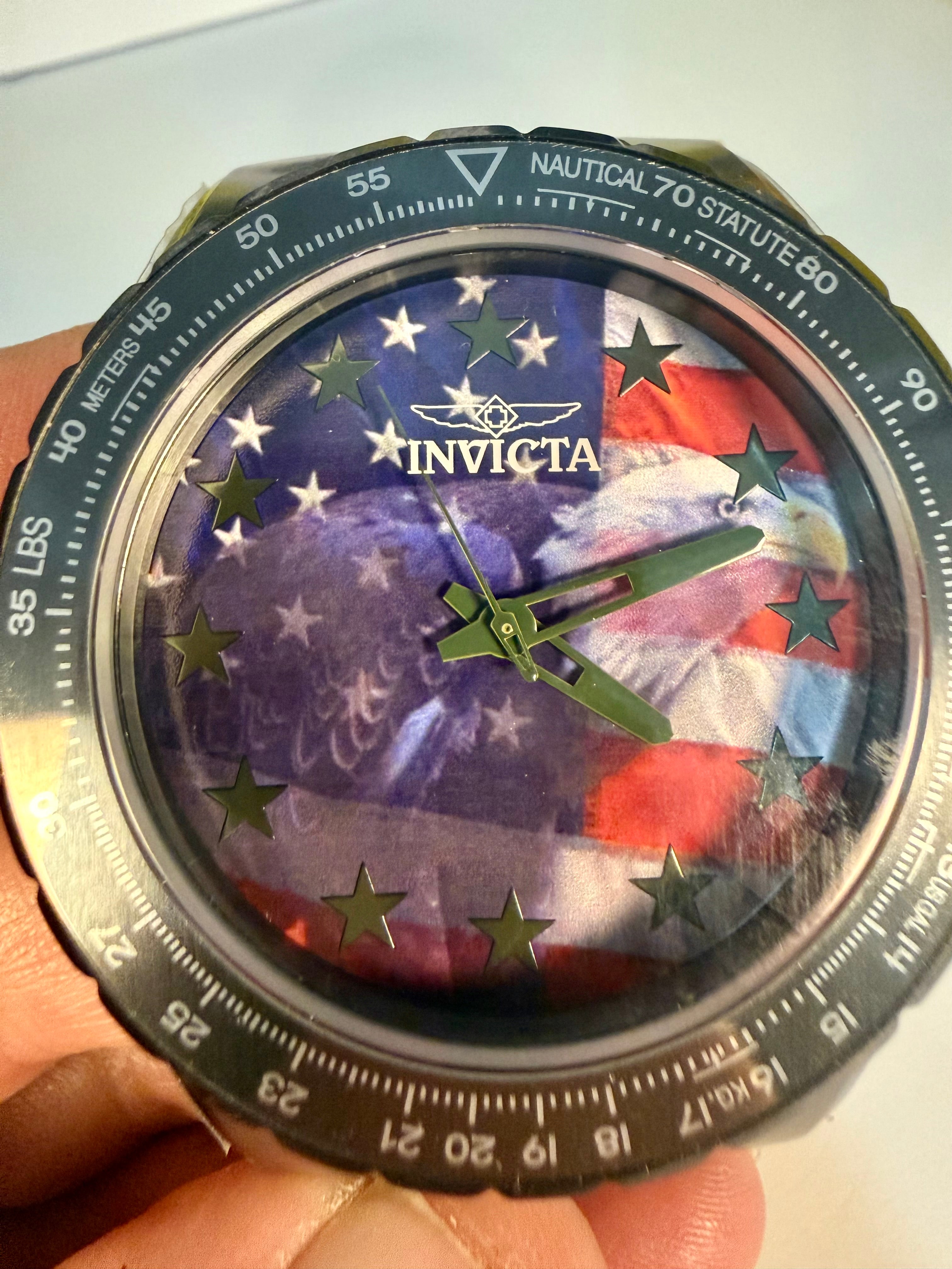 Invicta Aviator Patriotic Camo watch with American flag design held in a hand