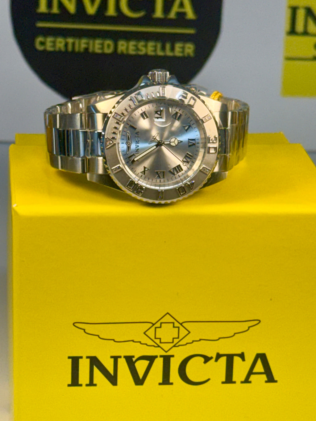Invicta Pro Diver 12819 Swiss Ronda 515 40mm 0.06ctw Diamond Silver Invicta watch on a yellow box with Invicta branding.