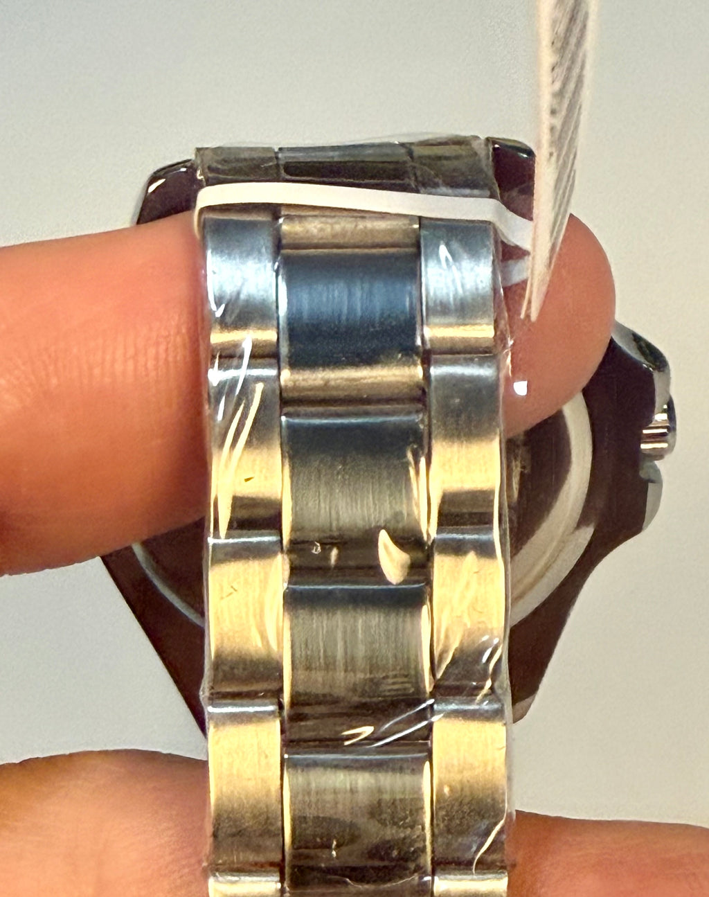 Close-up of a Montres Prestige 42mm Mens Pro Diver   silver watch band on a wrist with a neutral background