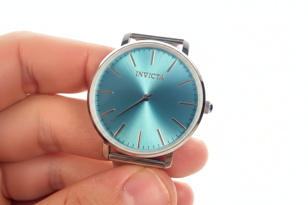 Hand holding an Invicta Angel Starlight  blue Invicta watch against a white background