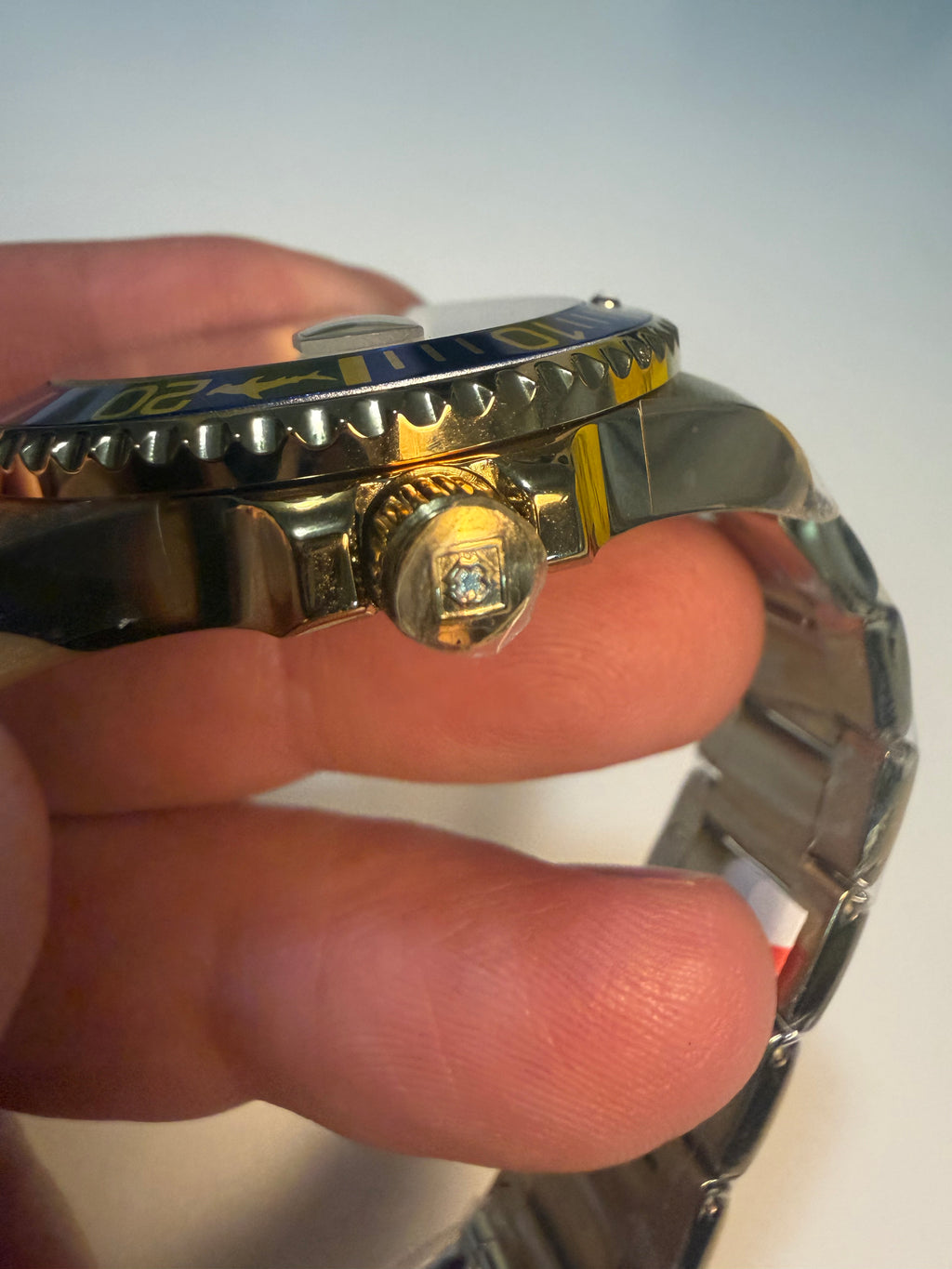 Close-up of a person wearing a Invicta 38mm Unisex Pro Diver on a plain background