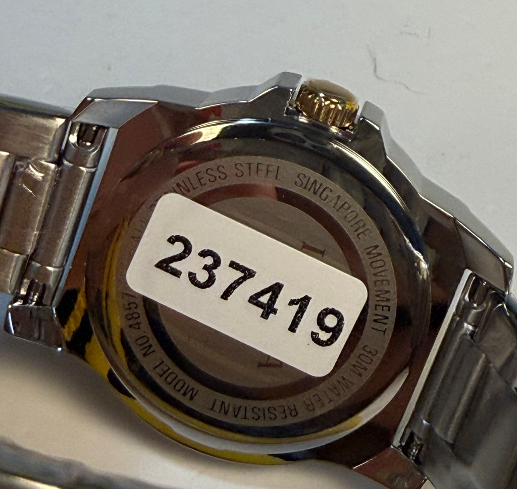 Close-up of a watch case with a serial number label onSpeedway Ladies 34mm Combo a white background