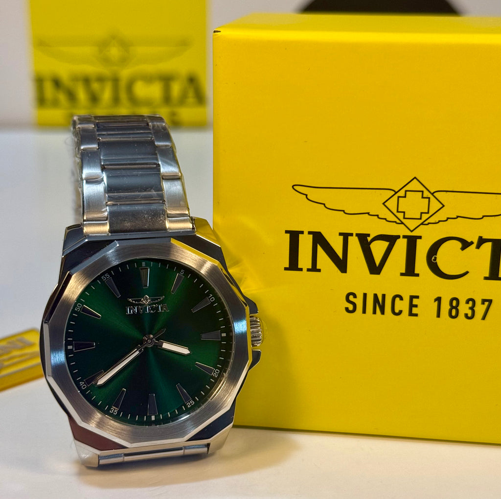 Mens 42mm Invicta Speedway Dominus Silver watch with green face on a yellow Invicta box