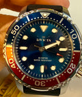 Invicta Mens Pro Diver 48mm Silicone band Watch with blue face and red and orange bezel held by a hand