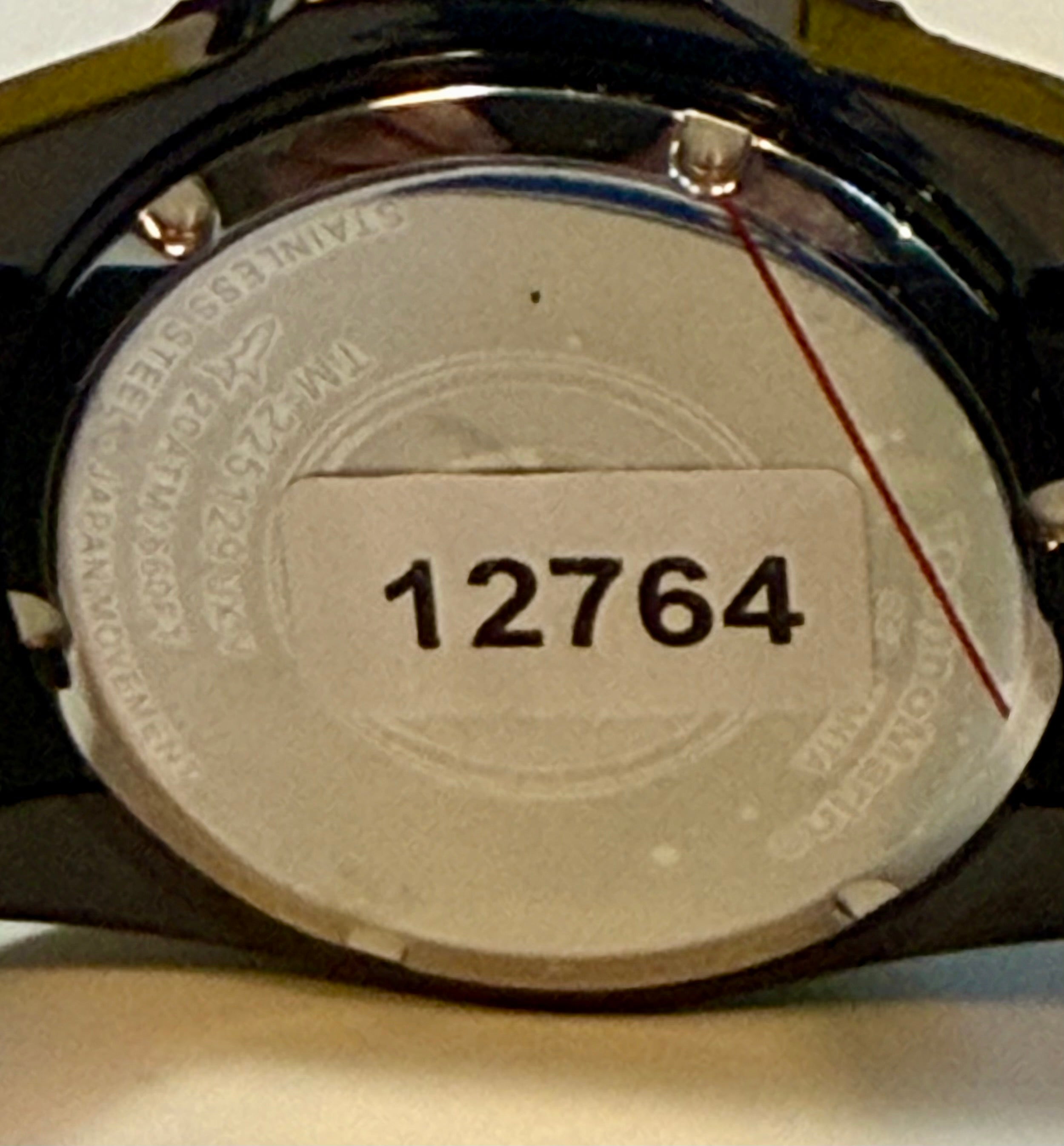 Close-up of a TechnoMarine 42mm Trible Black Manta Sea watch case with the number 12764 engraved on it.