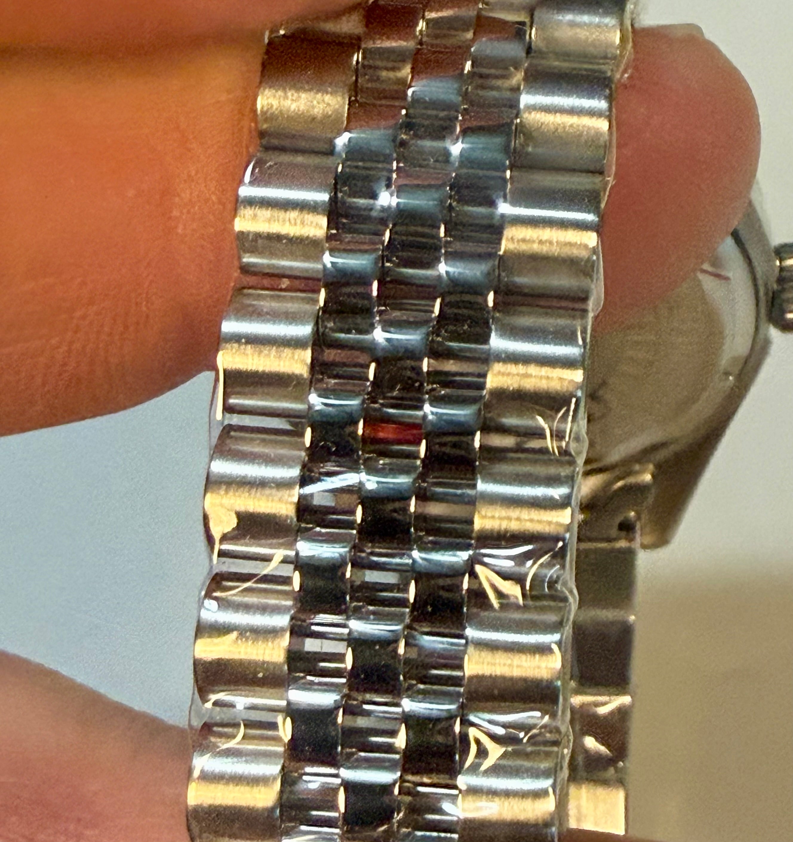 Close-up of aInvicta Ladies Specialty 36mm watch band on a wrist with a light background