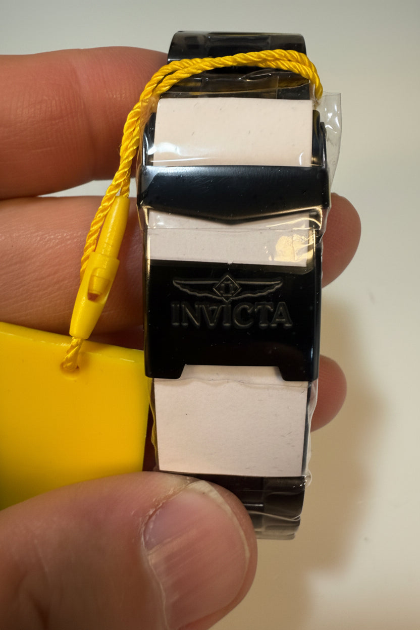 Close-up of a Invicta Mens Specialty Fortitude  watch strap with a yellow cord, held by fingers.
