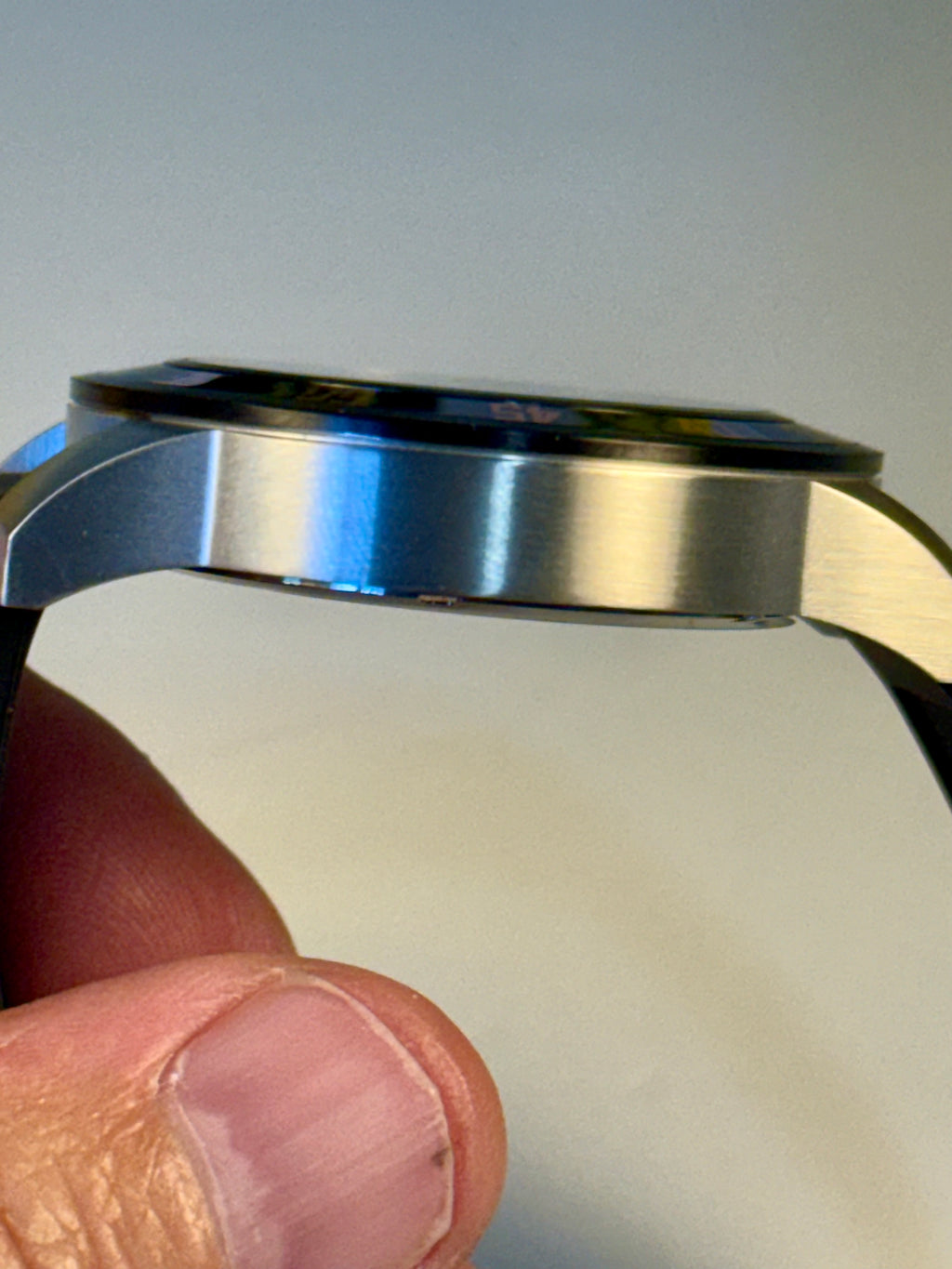 Close-up of a person holding a Invicta Specialty Compass with a blurred background
