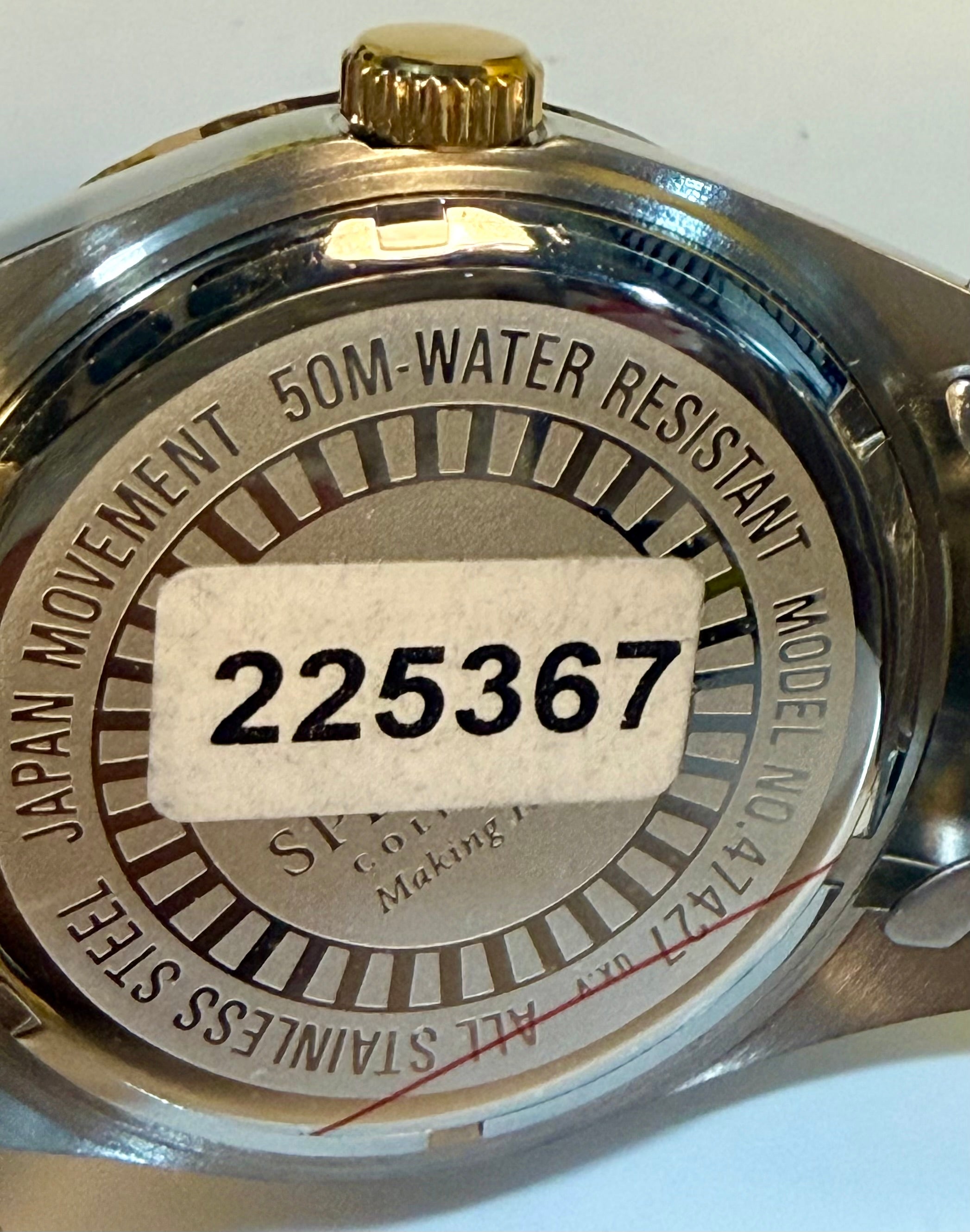 Back of a   Invicta Mens Specialty Belmont 43mm watch with branding and model number on a white background