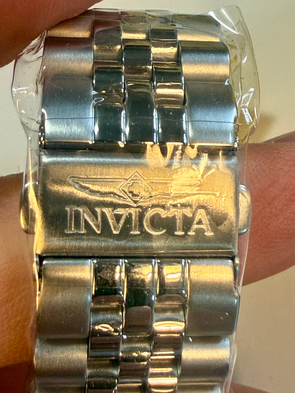 Invicta Specialty Windsor 43mmwatch band held in a hand with a neutral background
