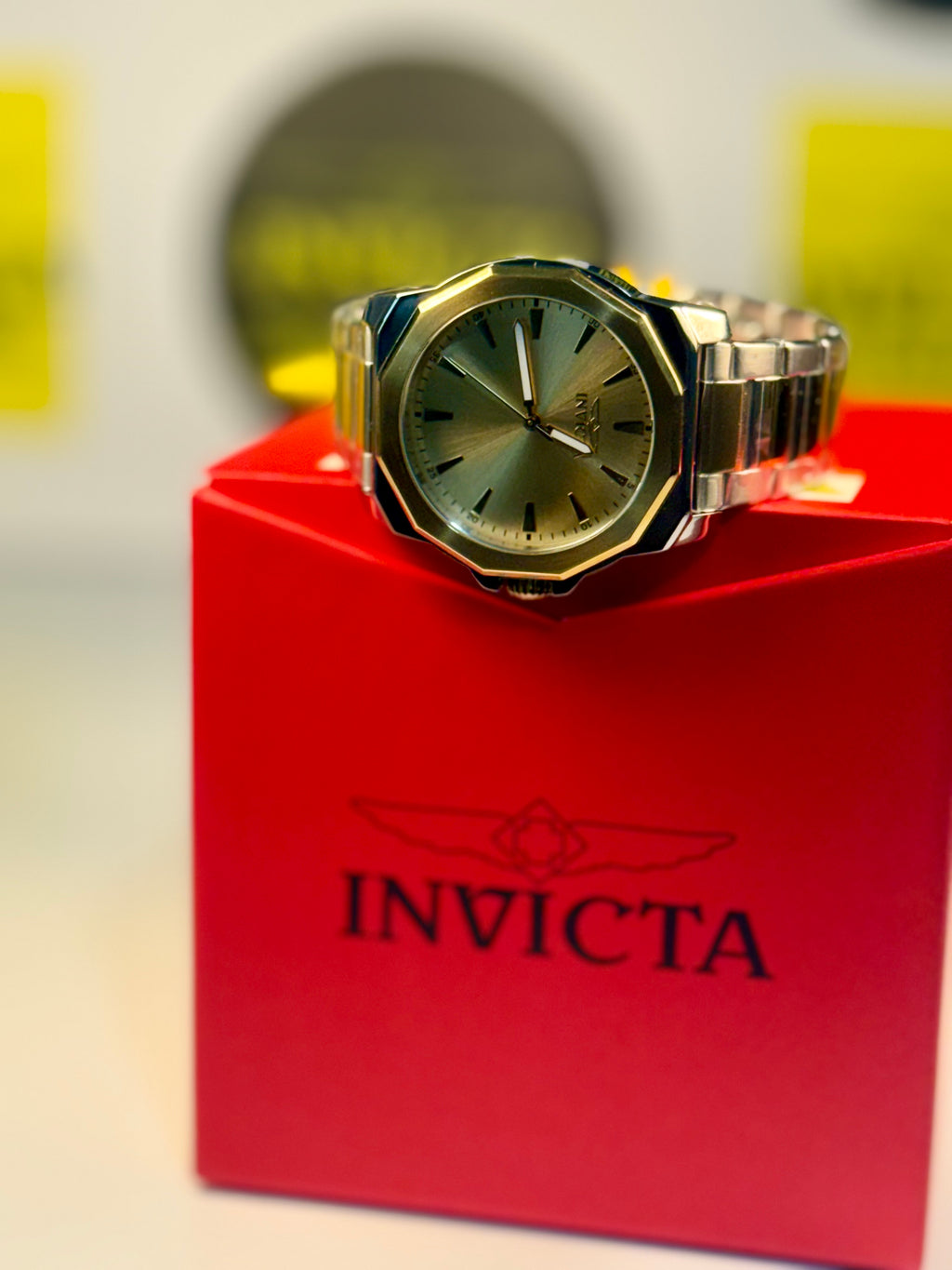 Invicta Speedway Gold watch on a red Invicta box with a blurred background