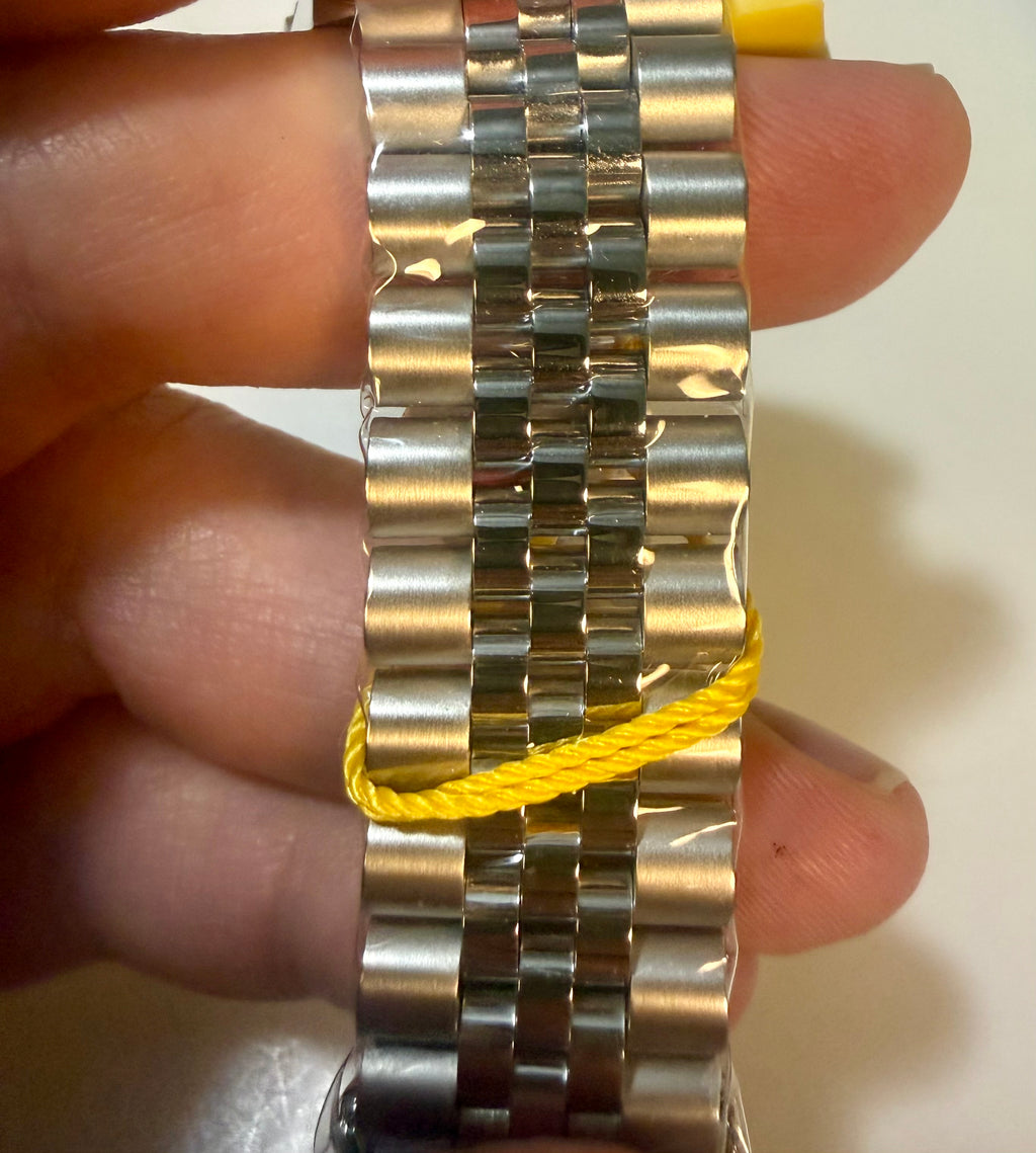 Invicta Mens Pro Diver 43mm Gold and silver watch bracelet on a hand with a plain background