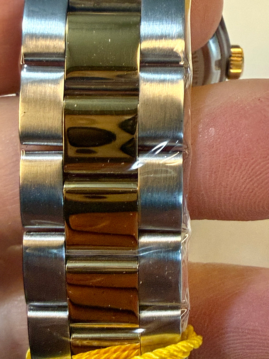 Close-up of a Invicta Mens Specialty Belmont 43mm silver watch band on a wrist.