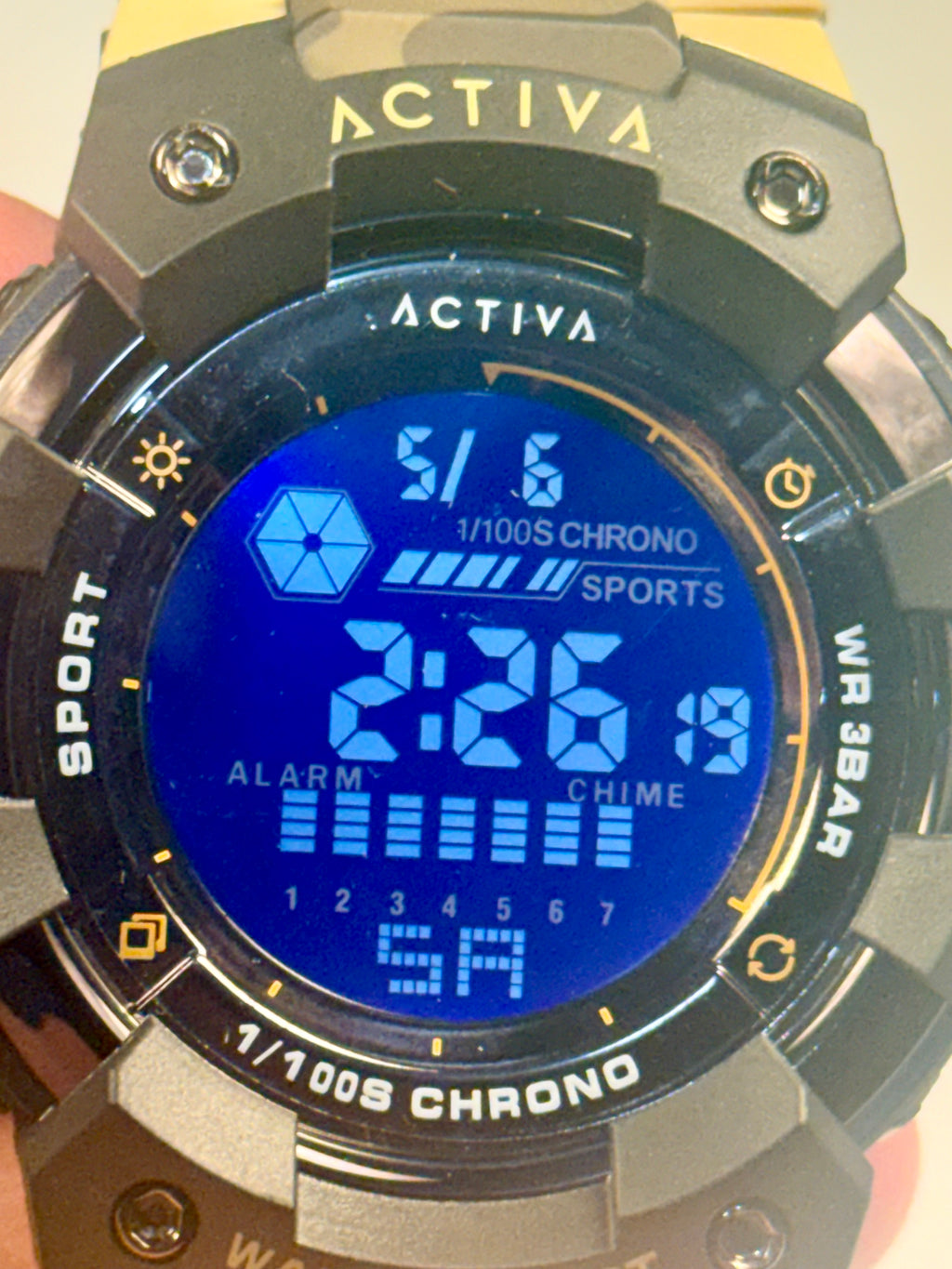Activa Camo Sport Watch Digital watch with blue screen displaying time and functions, brand 'Activa' visible.