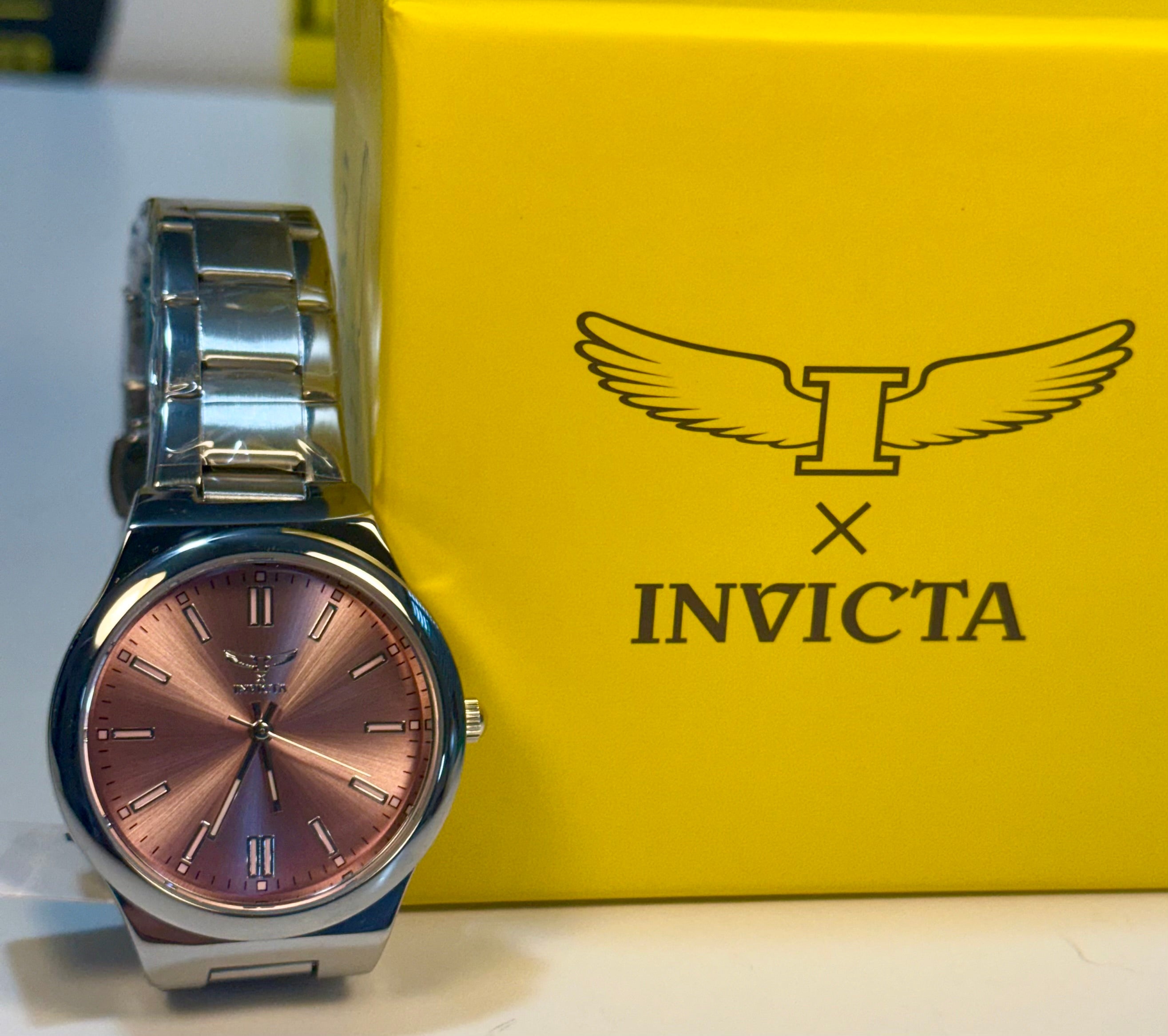 Invicta Ladies Celestial I Silver watch with a rose gold face on a yellow Invicta box