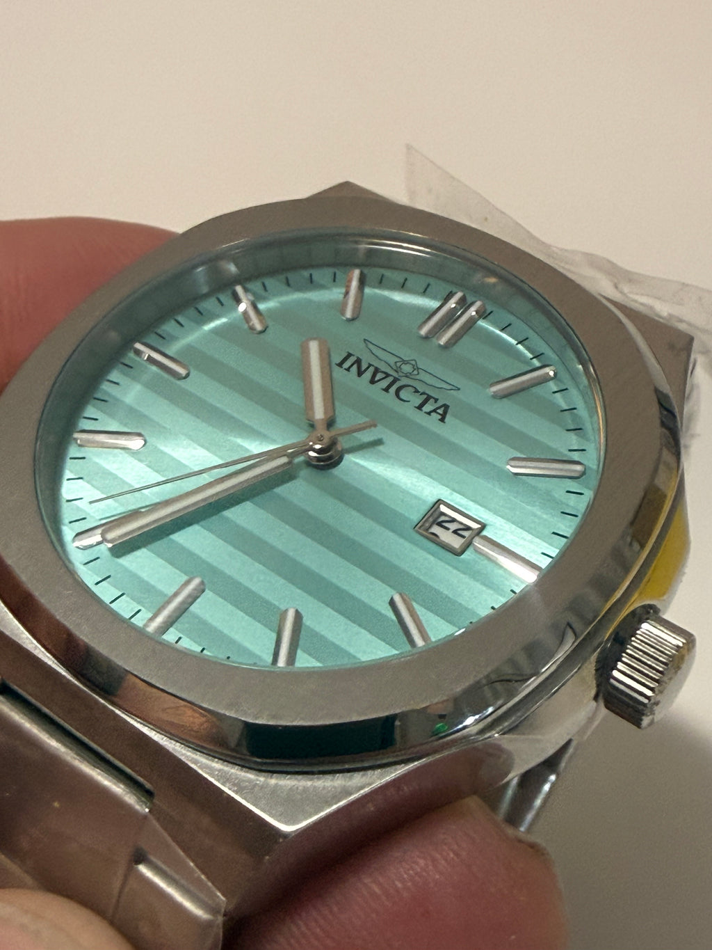 Invicta Speedway Vantage Men's Watch - 43mm. Steelwith a light blue face held in a hand against a neutral background