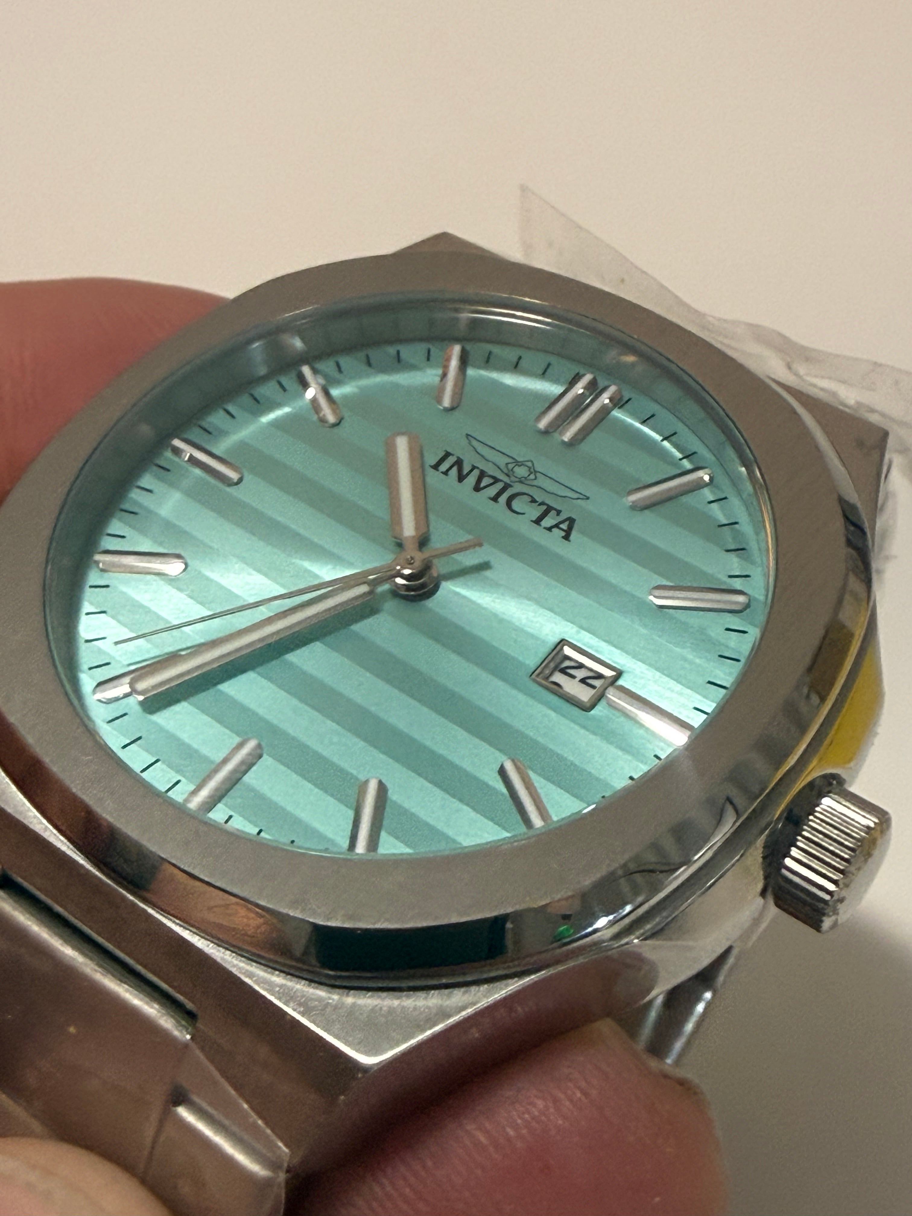 Invicta Speedway Vantage Men's Watch - 43mm. Steelwith a light blue face held in a hand against a neutral background