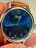 Mens Celestial Blue Sunray Dial Invicta watch with blue face held in a hand