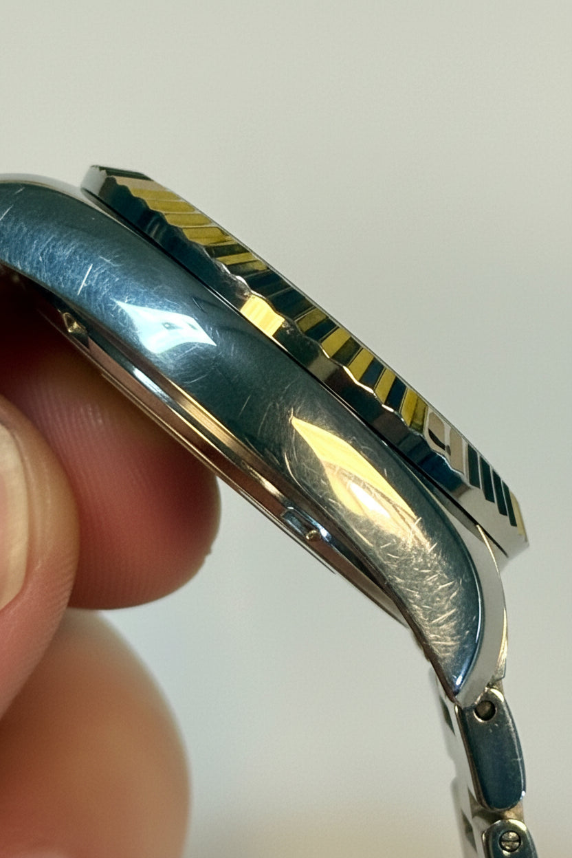 Close-up of a Invicta Ladies Specialty 36mm  held by a finger against a white background