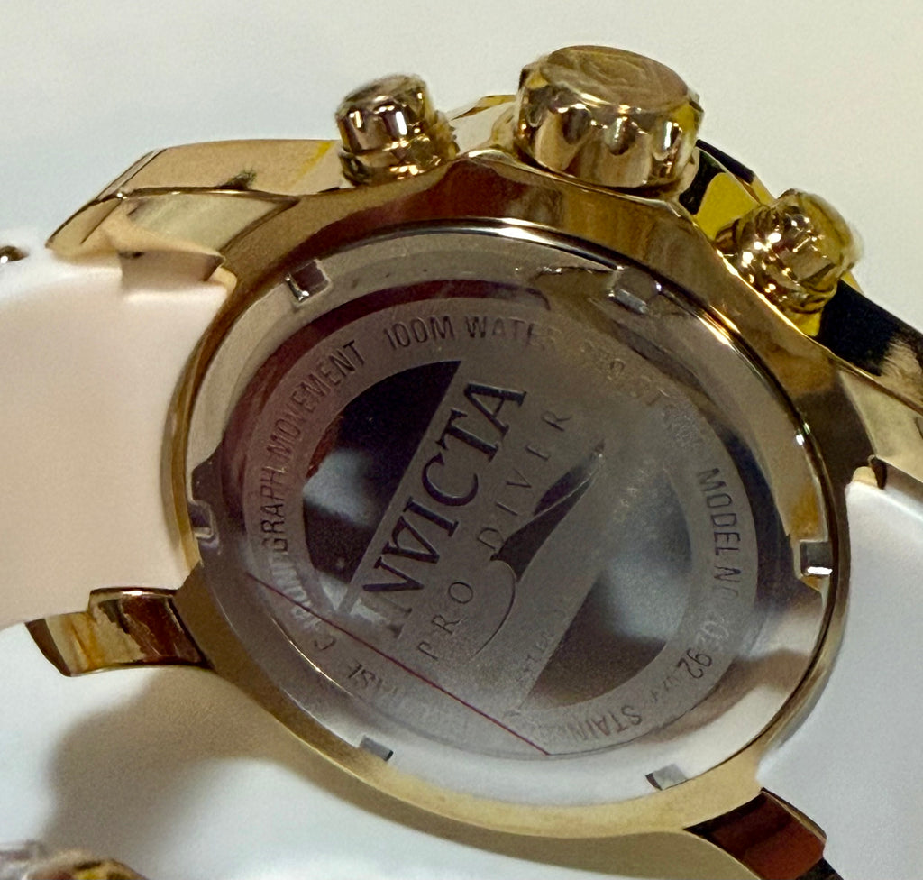 Gold watch case with 'Invicta' branding on a white background