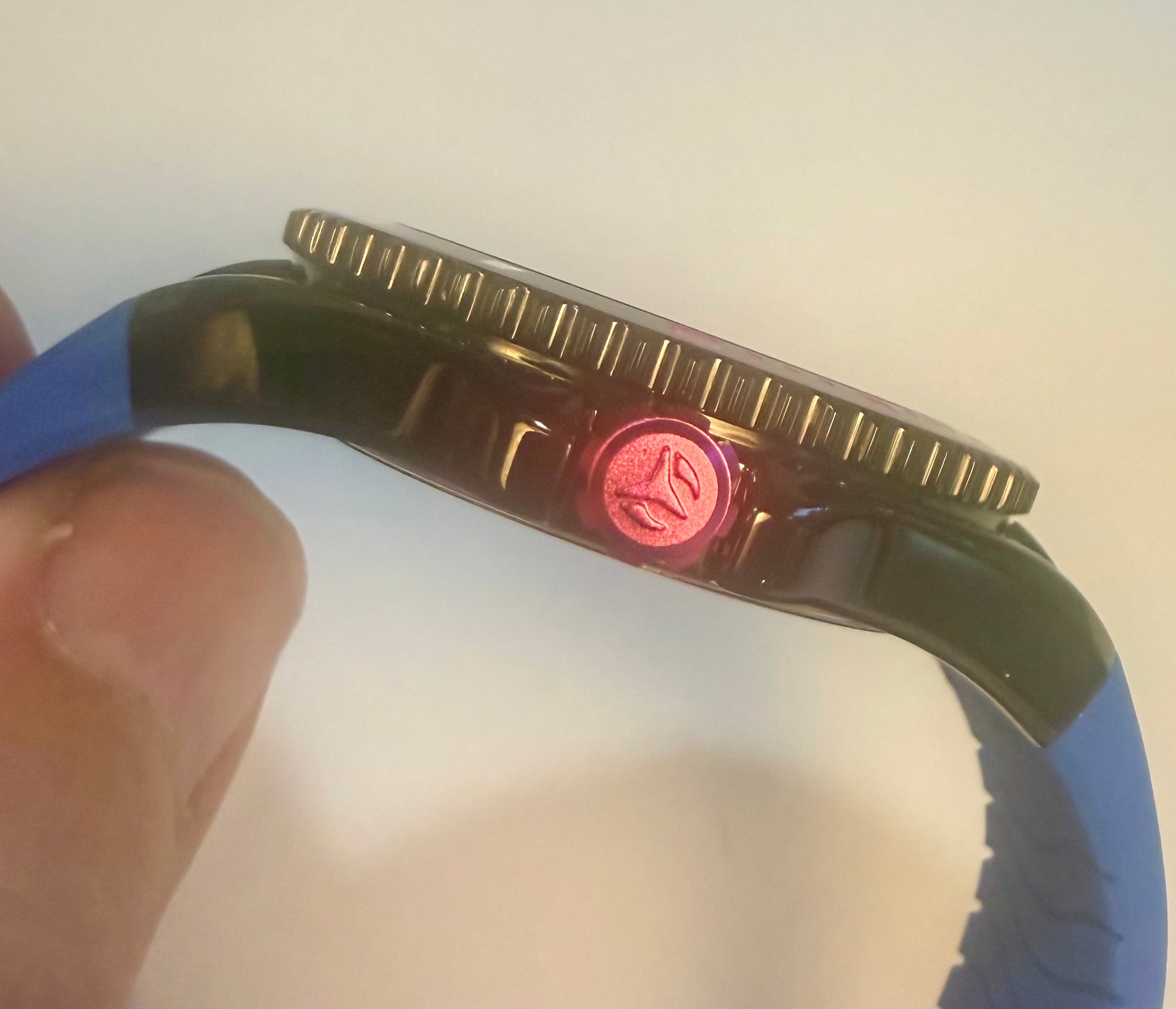 Close-up of a Techno Marine Racing Legends 44mm Wristwatch  watch with a red light on a blurred background