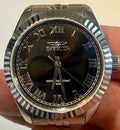 Ladies Specialty Windsor 36mm Silver Invicta watch with black dial held in hand