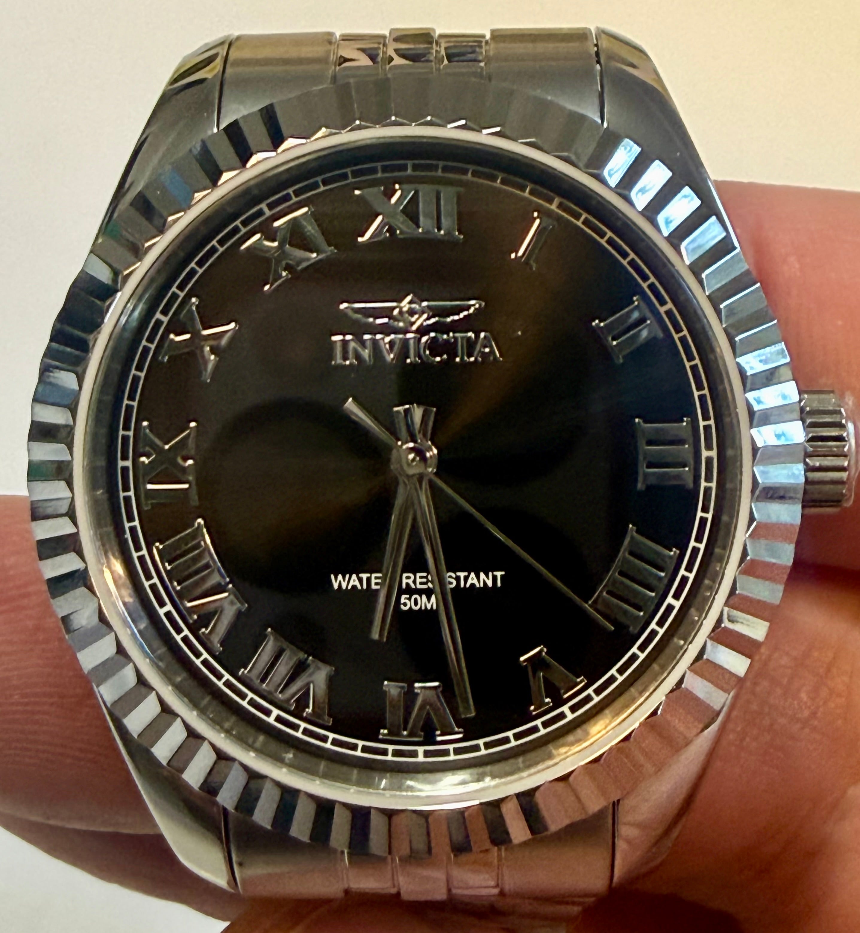 Ladies Specialty Windsor 36mm Silver Invicta watch with black dial held in hand