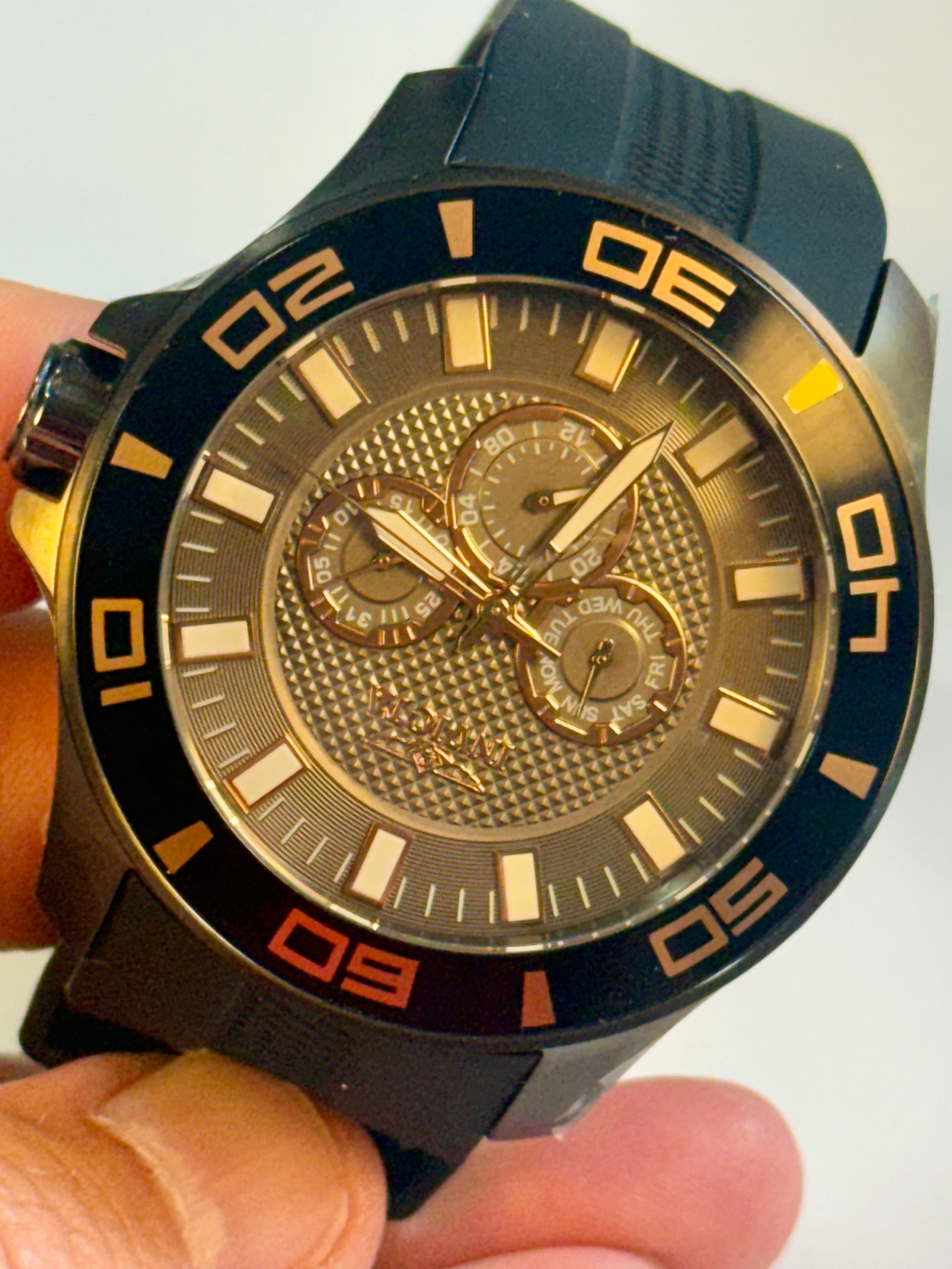 Invicta Mens Pro Dvider Chronograph Gold and black watch held in a hand with a white background