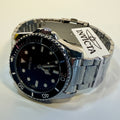 69401 Invicta Mens Pro Diver Vitreos Stainless Steel Bracelet Black Dial 42mm lying on a flat surface
