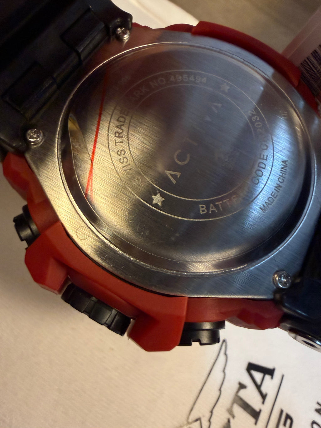 Close-up of a watch case with Activa  branding on a white background