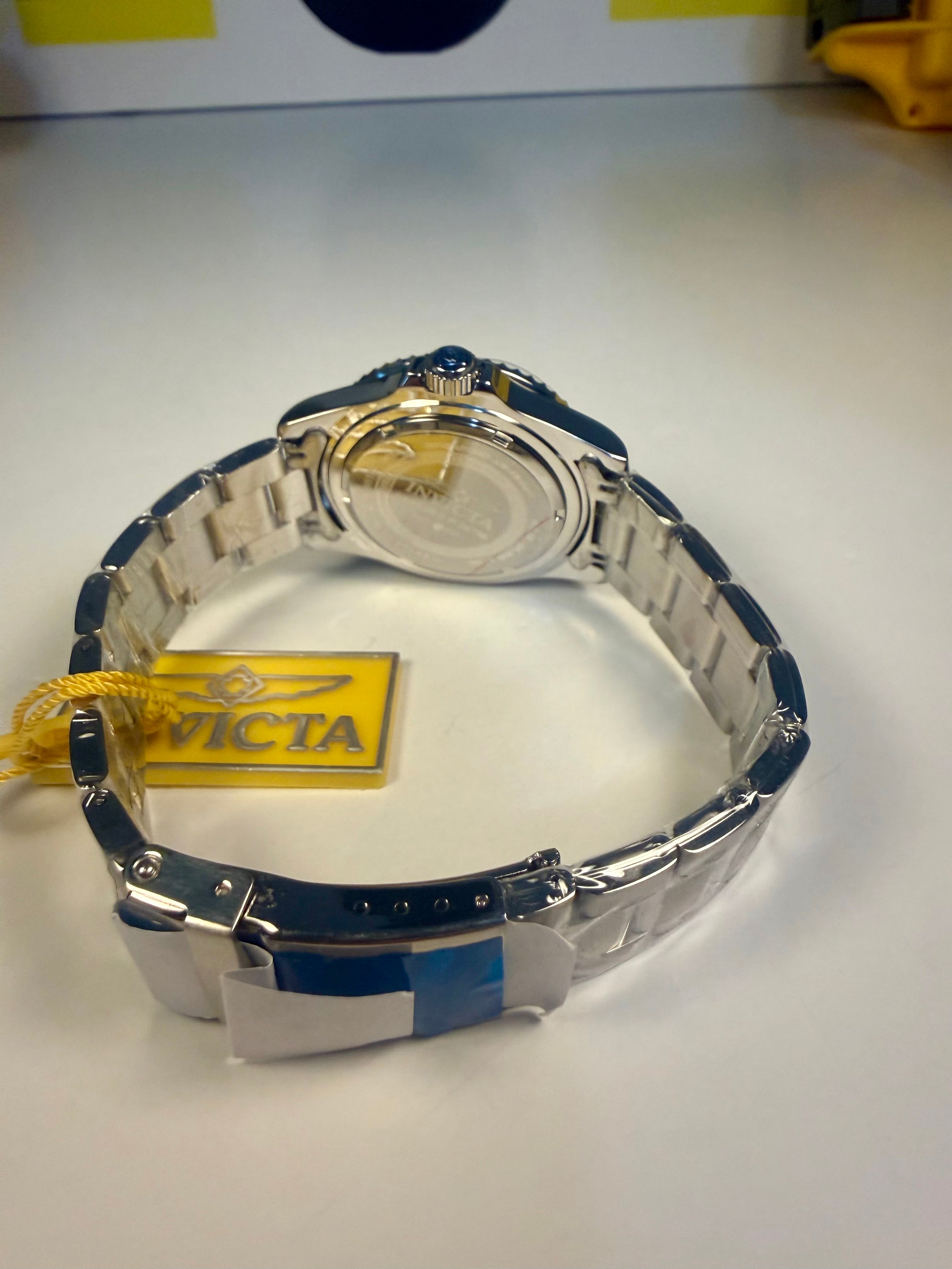Invicta Specialty Rowan Watch with blue and silver band on a white surface, Victa brand visible