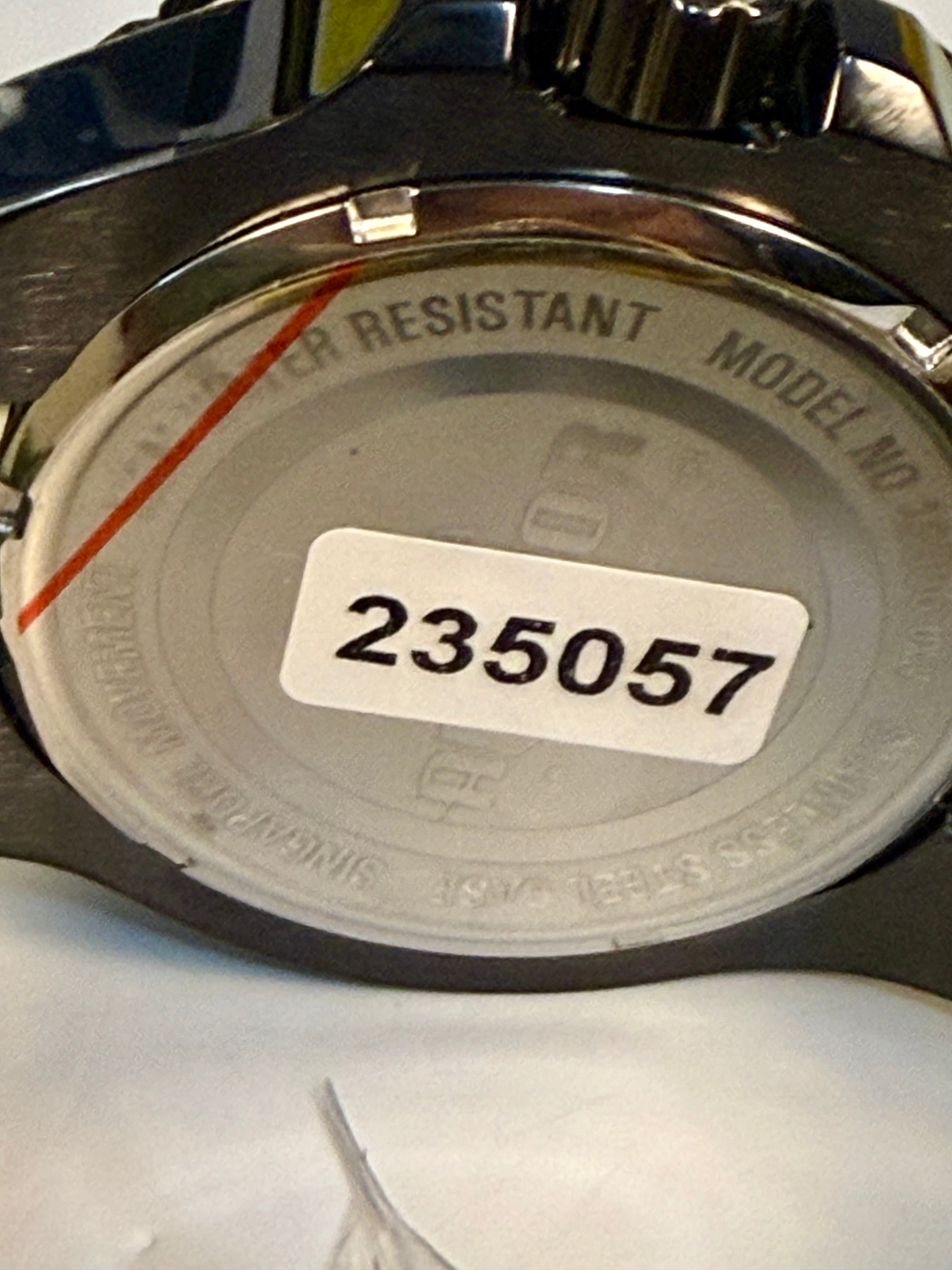 Back of a Invicta Aviator Patriotic Camo  watch with a model number label on a white background