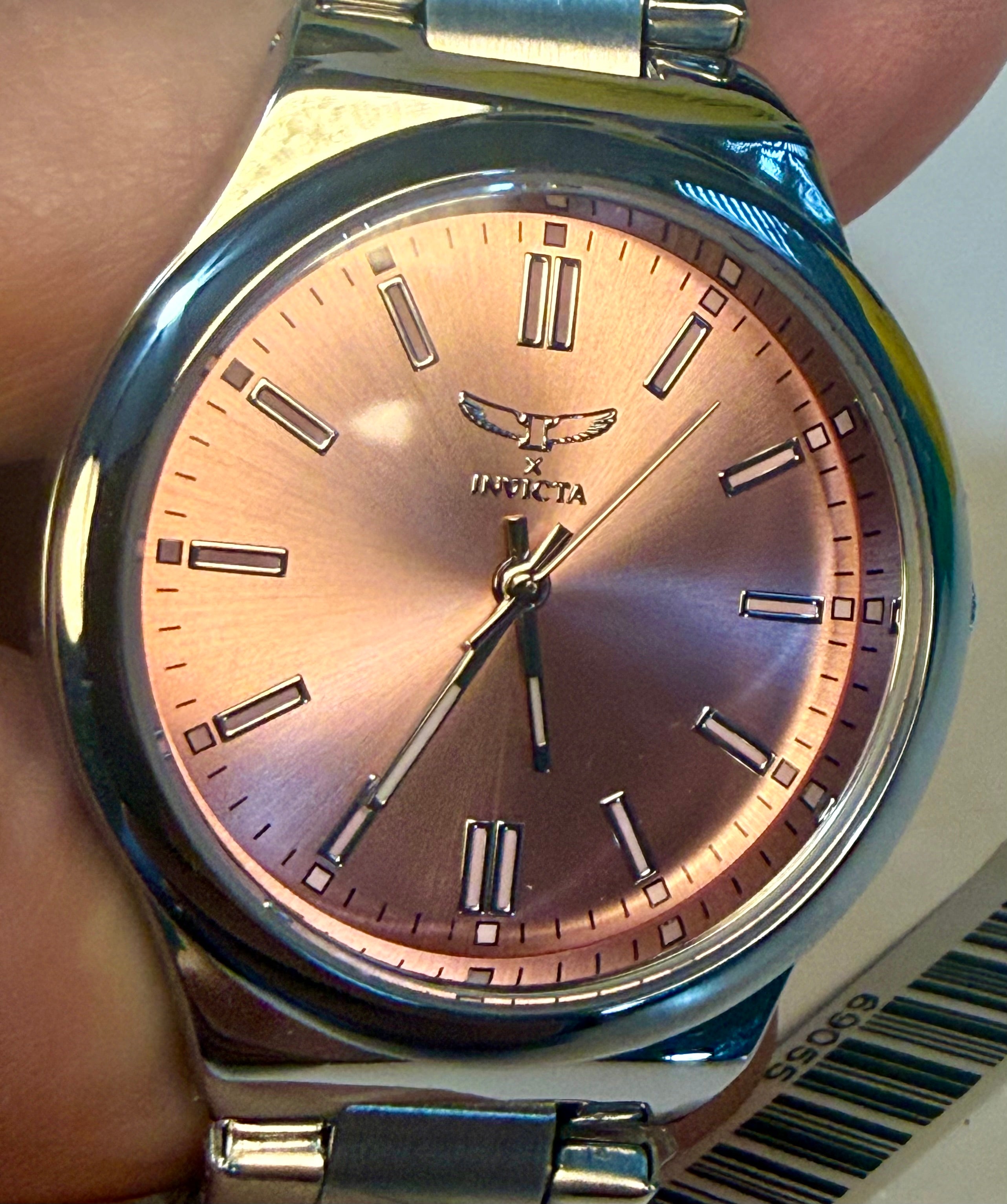 Invicta Ladies Celestial I Silver watch with a rose gold face on a wrist, brand 'Ingersoll' visible