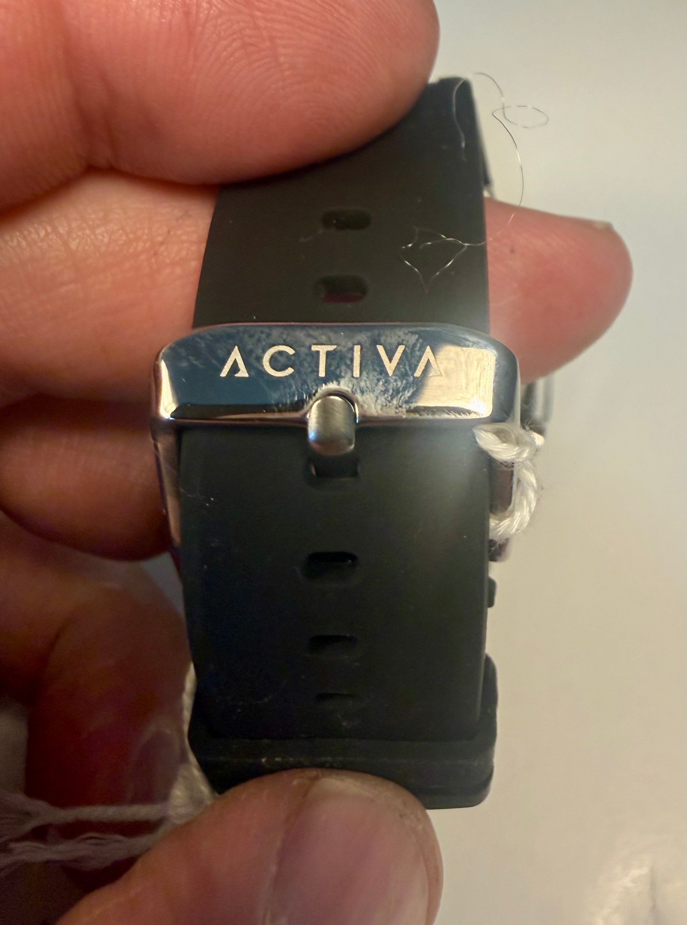 Activa Kaleido Rainbow Black watch strap with 'Activa' branding held in a hand against a white background